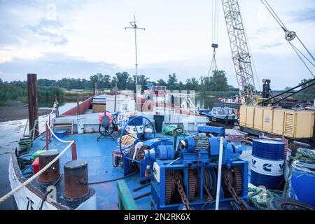 Brody, Lubusz Voivodeship, Poland. 15th Aug, 2022. Construction machinery carrying out regulation works at the Odra river in order to adapt it to the class III waterway in Brody village. The Odra River is an important communication route, it is part of the E30 waterway connecting the Baltic Sea with the Danube in Bratislava. The E30 waterway in Poland covers the Odra River from the border with the Czech Republic to Swinoujscie, where the Swinoujscie LNG terminal is located.WWF Germany and experts from the IGB Leibniz-Institute of Freshwater Ecology and Inland Fisheries call for the cessation Stock Photo