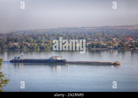 empty dry-cargo ship sailing on the river Stock Photo