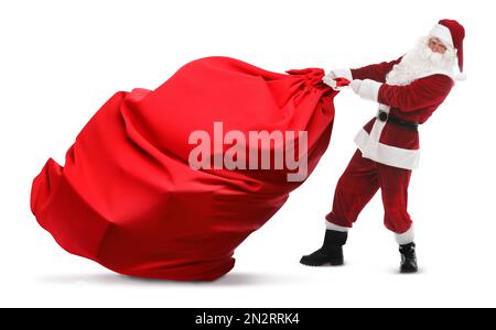 Santa Claus pulling enormous red bag full of Christmas gifts on white ...