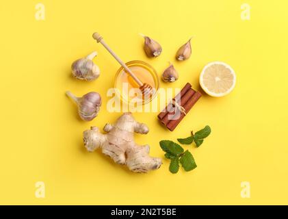 Flat lay composition with different natural antibiotics on yellow background Stock Photo
