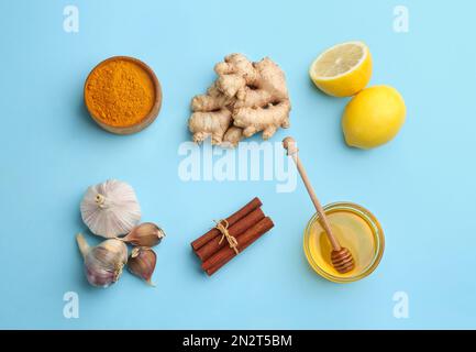 Flat lay composition with different natural antibiotics on light blue background Stock Photo