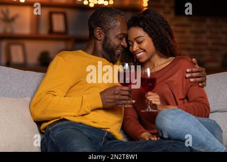 Loving black husband hugging his pretty wife, home interior Stock Photo