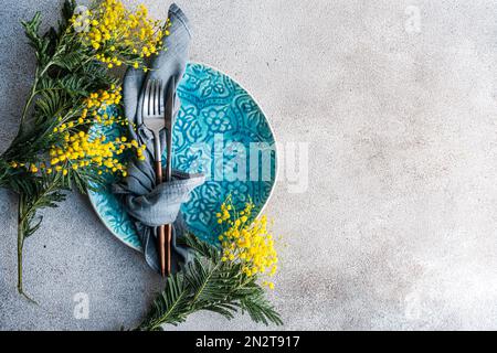Table setting for Easter dinner with mimosa Stock Photo