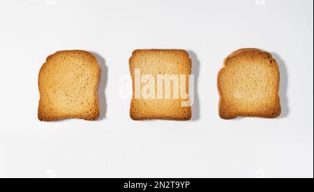 Top view of crispy wholemeal crackers bread rusks different shaped toast slices isolated on white background Stock Photo