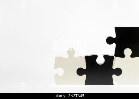 Set of black and white puzzle pieces isolated on white background in frame Stock Photo