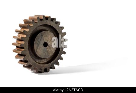 Brown vintage gear from old mechanism made of lumber rolling against while background Stock Photo