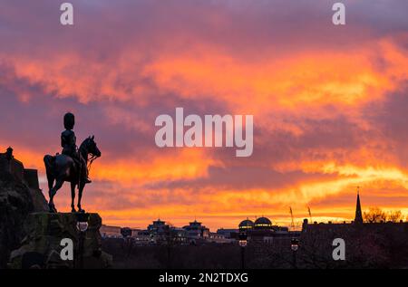 Orange sunset with silhouette of Royal Scots Greys equestrian soldier horse monument, Princes Street, Edinburgh, Scotland, UK Stock Photo