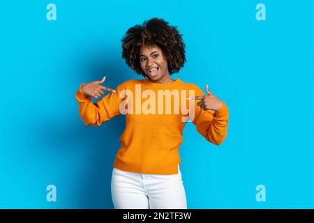Cool pretty young black lady pointing at herself Stock Photo