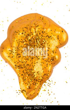 Cosmetic gold spot. Gold glitter paint swatch isolated on white background Stock Photo