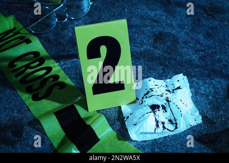Bloody napkin and crime scene marker with number Stock Photo - Alamy