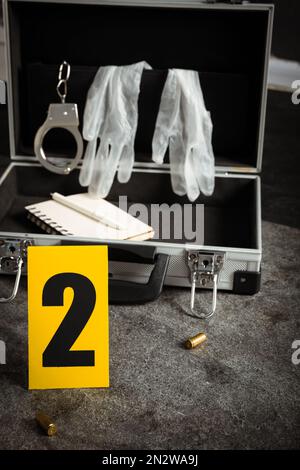 Handcuffs and crime scene marker with number one isolated on white ...