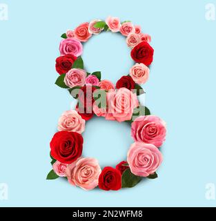 International women's day. Number 8 made of beautiful flowers on pale blue background, top view Stock Photo