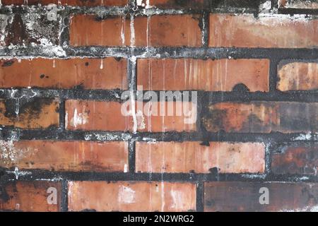 Dirty red brick texture with stains and white drips Stock Photo