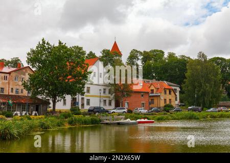 TALSI, LATVIA, SEPTEMBER 10, 2022: Colorful old town houses and church with lake reflection in Talsi Latvia. Stock Photo