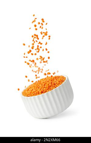 Lentil seeds flying out of white plate isolated on white background Stock Photo