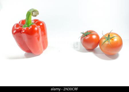 Red bell pepper , Red tomatoes on the White Blackground Used in cooking and eating fresh Stock Photo