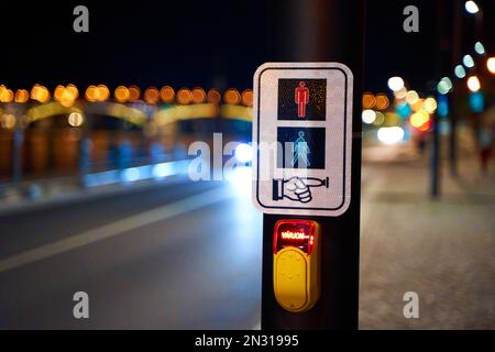Night photo of a button that turns on a traffic light for a pedestrian crossing. Stock Photo