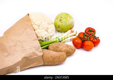 Fresh organic vegetables in a sustainable grocery bag isolated with focus stacking against a white background Stock Photo