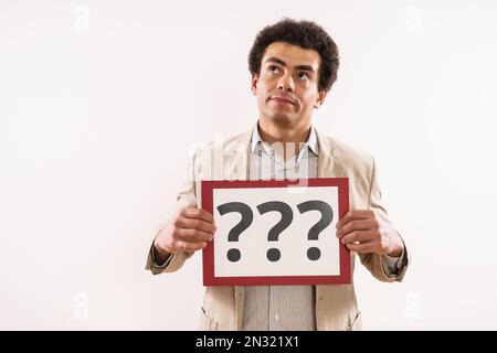 Image of confused businessman  showing paper with question marks. Stock Photo