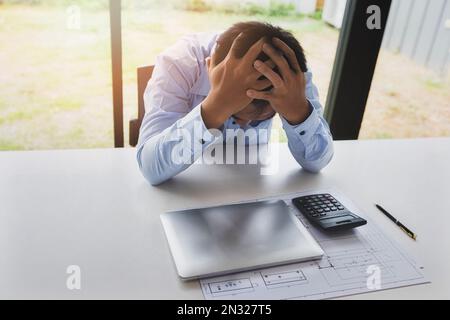 Architect in stress, tired, sad, disappointed with project problem. Stock Photo