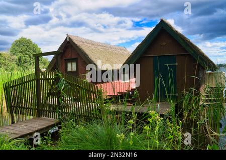 Fishing lodge on the lake near Krakow on the lake. Inland fishing. Vine roof on the house. Vacation resort in Germany. Landscape photo from nature Stock Photo