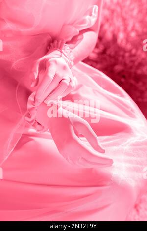 Beautiful designer multicolored gloves on a background of pink dresses Stock Photo