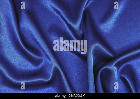 Texture of soft blue silk fabric. Smooth wavy fabric. Can be used as Elegant wallpaper design. Abstract background. Top View, Copy Space Stock Photo