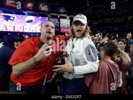 New England Patriots coaching assistant Steve Belichick, right, celebrates  with friends in the stands after the Patriots beat the Seattle Seahawks in  the NFL Super Bowl XLIX football game Sunday, Feb. 1,