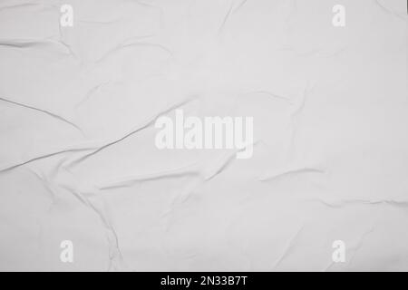 Top view of white creased blank poster as background, closeup Stock Photo