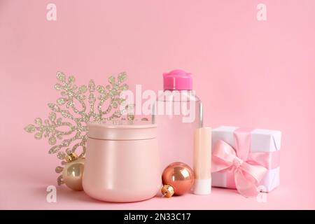 Beautiful composition with cosmetic products on pink background. Winter care Stock Photo