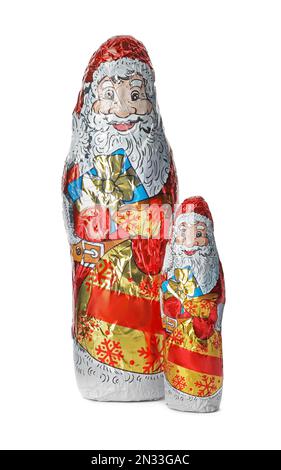 Chocolate Santa Claus figures in foil wrappers on white background Stock Photo