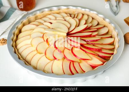 An English cake in a baking dish on a wooden board and a white wooden  table. Selective focus Stock Photo - Alamy