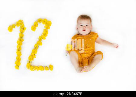 12-month-old baby girl. Baby milestone two months. Twelve month old baby Stock Photo