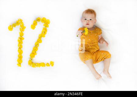 12-month-old baby girl. Baby milestone two months. Twelve month old baby Stock Photo