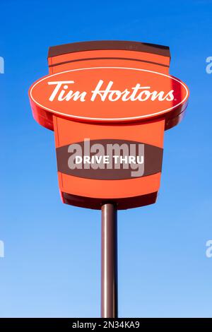 Tim hortons sign tim hortons uk sign against a clear blue sky background Stock Photo