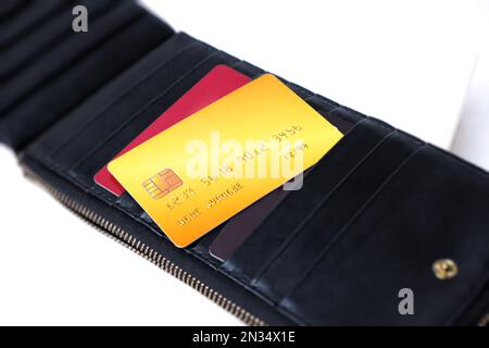 Credit card in black leather wallet on white background, Selective focus, Credit card payment concept Stock Photo