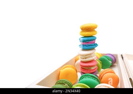 Colorful macaron or macaroons in a box isolated on white background, macarons high stack Stock Photo