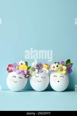 Funny Easter Eggs, hand drawn faces. Easter holiday concept with cute handmade eggs in floral wreath crowns Stock Photo