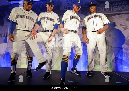 Seattle Mariners' Charlie Furbush, left, points out new socks as teammate  Nelson Cruz looks on as the team's new alternate Sunday uniforms are  modeled during an unveiling, Friday, Jan. 23, 2015, in