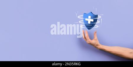 Businessman hold Shield with plus Low polygonal icon, medicine icon.Health shield.Medical logo template,protection symbol with cross sign,healthcare s Stock Photo