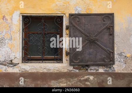 A window with traditional metal shutter in an historic building Skofja Loka in Gorenjska, Slovenia Stock Photo