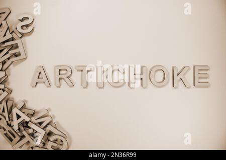 ARTICHOKE in wooden English words language capital letters spilling ...