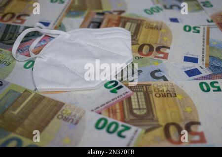 face mask lies on euro banknotes Stock Photo