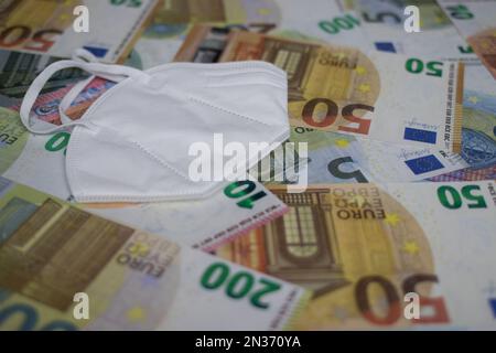 face mask lies on euro banknotes Stock Photo