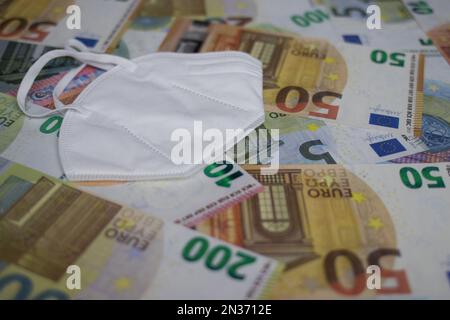 face mask lies on euro banknotes Stock Photo