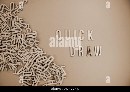 DRAW in wooden English language capital letters spilling from a pile of ...