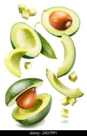 Lot of avocado fruits flying in the air isolated on white background. Stock Photo