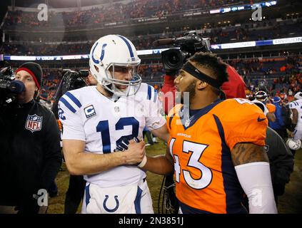 Indianapolis Colts quarterback Andrew Luck (12) greets Denver Broncos  strong safety T.J. Ward (43) after an NFL divisional playoff football game,  Sunday, Jan. 11, 2015, in Denver. The Colts won 24-13 to