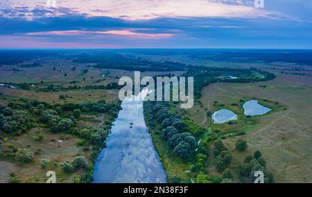 Beautiful Ukrainian nature background. Drone view on riverbank of the Seym river and amazing cloudscape over it. Summertime. Stock Photo