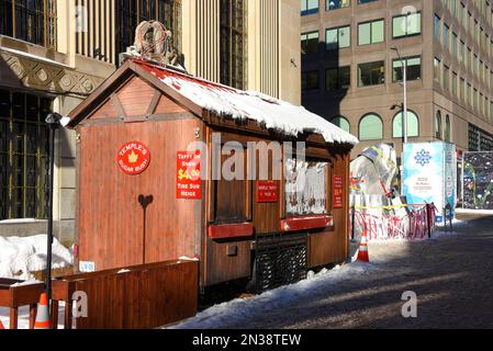 Ottawa, Canada - February 6, 2023: Portable taffy on snow shack on Sparks Street during Winterlude ice sculpture event. An adjacent ice sculpture is c Stock Photo